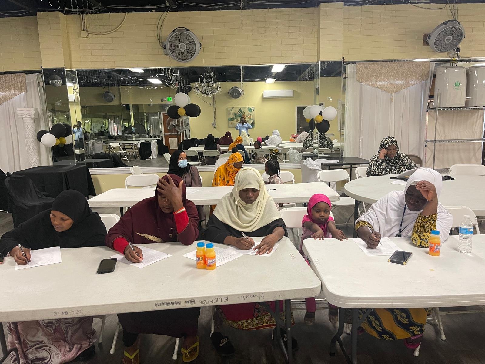 Community members writing together at a gathering