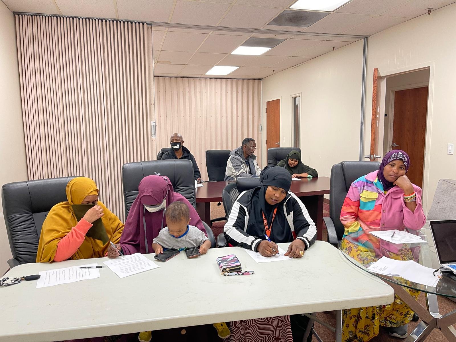 Families and community members taking part in a group session